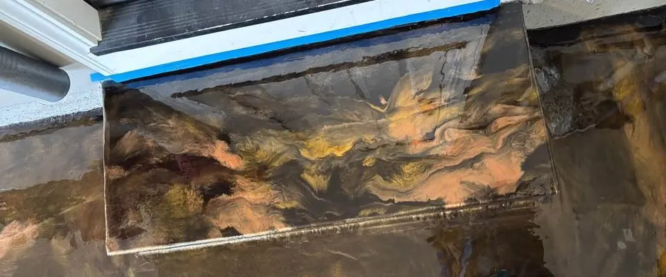 Metallic epoxy coating a garage entry step